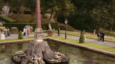 people are standing around in the formal garden