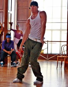 a man standing on top of a hard wood floor