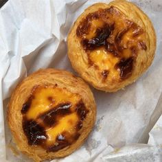 two pastries sitting on top of wax paper