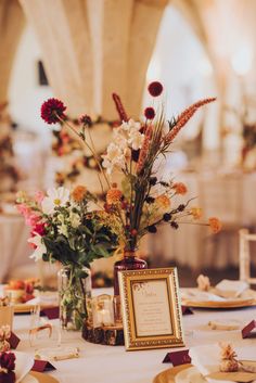 the table is set with flowers and place settings for an elegant wedding breakfast or reception