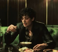 a man sitting at a table eating food