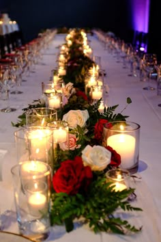 a long table with candles and flowers on it