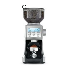 a coffee maker with beans in it on a white background, viewed from the side