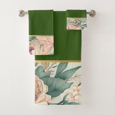 two towels hanging on a towel rack with green and pink florals in the background