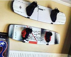 two snowboards mounted to the side of a wall