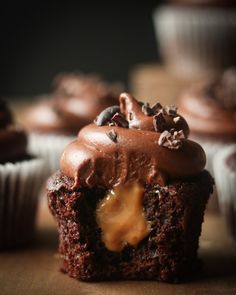 chocolate cupcakes with frosting and nuts on top