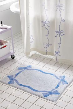 a bathroom with a bathtub and rug on the floor