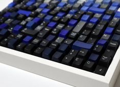 a blue and black keyboard sitting on top of a white table