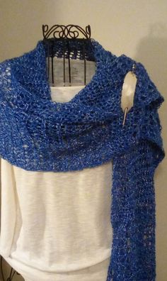 HAND CROCHETED SHAWL, WRAP, SCARF IN ROYAL BLUE AND WHITE This is a beautiful shawl made with a fine acrylic yarn. It is very big and can be worn in so many different ways. Since it is lightweight, it can be worn for all seasons. The color is blue with white running through it.  It measures approximately 16 ins. wide and 64 ins. long. Looks great with jeans and light enough to wear inside during the winter. Hand wash, lay flat to dry. A great gift! SHAWL PIN NOT INCLUDED. All items made in a smo Handmade Blue Shawl For Winter, Blue Crochet Shawl One Size, Blue Crochet Yarn Shawl, Blue Hand Knitted Winter Shawl, Hand Knitted Blue Winter Shawl, Hand Knitted Blue Shawl For Winter, Hand Knitted Blue Shawl One Size, Crocheted Shawl, Shawl Pin