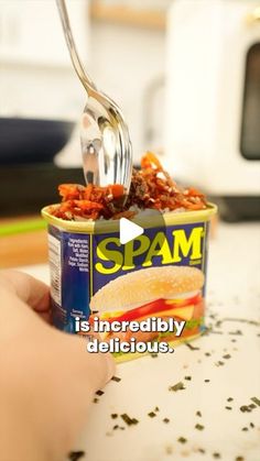 a person is holding a spoon over a can of spam food with the caption spam is incredibly delicious delicious