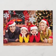 a christmas card with three people wearing santa's hats and smiling at the camera