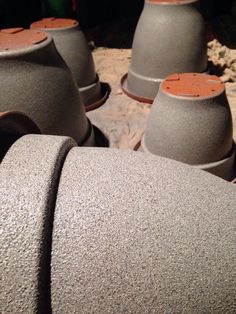 several gray vases sitting next to each other