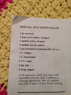 a recipe for macaroni salad on a crocheted tablecloth