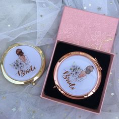 two compact mirrors with bride and groom pictures on them in a pink box next to a white net