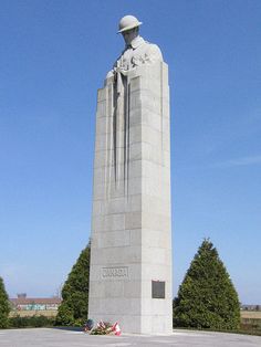 there is a large monument with a statue on it's side and trees in the background