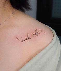 a woman with a tattoo on her shoulder that says,'love is in the air '