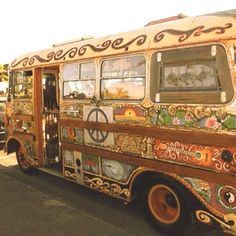 an old bus is painted with colorful designs