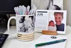 a desk with a coffee mug, pen and calendar on it