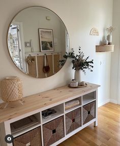 a room with a large mirror and some baskets on the shelf next to each other