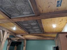 a room with wooden ceiling and green walls