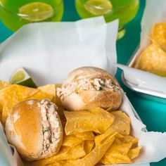 two sandwiches and chips on a blue tray