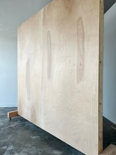 the plywood panel is being prepared to be used as a headboard for a bed