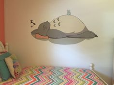 a child's bedroom with a bed and wall decal