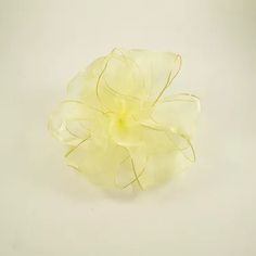 a yellow flower on a white surface with no background or image to describe, it looks like something from the movie's avatar