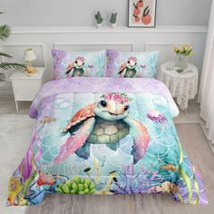 a bed with an ocean themed comforter and pillows