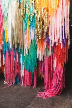 colorful streamers hanging from the ceiling in front of a building