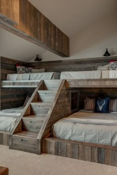 bunk beds with stairs are in the middle of a room