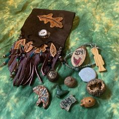 an assortment of items are laying on a green cloth covered tablecloth, including buttons and beads