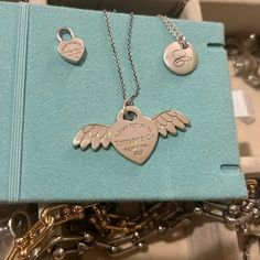 New & Retired. Rtt Angel Wings Charm, Very Popular Piece & No Longer Available. Brand New Condition With Possible Hairline Scratches From Handling But Not Viewable When Wearing. Took Picture Next To Other Charms For Size Comparison. Comes With Pouch & Original Box. (Chain And Other Charms Are Not Included!) Trusted Seller Tiffany Jewelry Box, Return To Tiffany Necklace, Angel Wings Heart, Return To Tiffany, Tiffany Necklace, Size Comparison, Tiffany Heart, Box Chain, Angel Wings