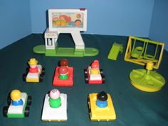 there are many toy cars and toys on the table in front of a small tv