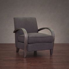 a gray chair sitting on top of a wooden floor