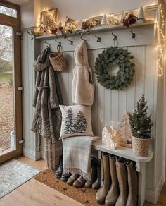 the entryway is decorated with christmas wreaths, stockings and boot boots for decoration