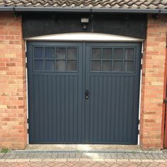 a brick building with two garage doors on each side and one door open to let in light