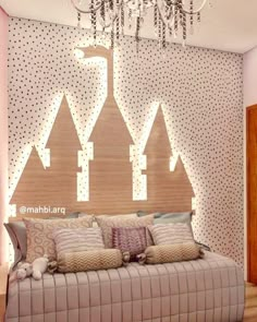 a bedroom with a bed, chandelier and wallpapered walls in the shape of houses