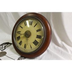 an old wooden clock with roman numerals on it's face and hands