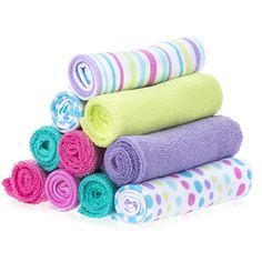 several towels stacked on top of each other in different colors and patterns, with one folded up to the side