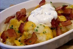 loaded cauliflower casserole with bacon and sour cream in a white dish