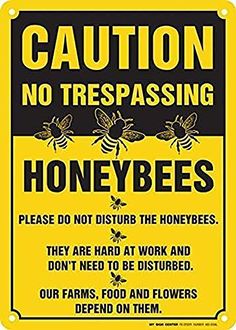 a caution sign that reads caution no trespassing honeybees please do not disturb the honeybees they are hard at work and don't need to be disturbed