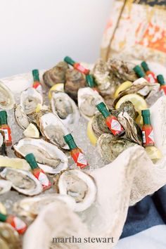 several oysters on ice with bottles in the background