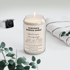 an image of a candle that is next to some towels