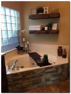 a bathtub with two shelves on the wall above it