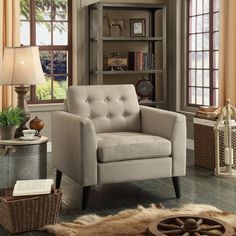 a living room filled with furniture and a book shelf next to a window covered in curtains