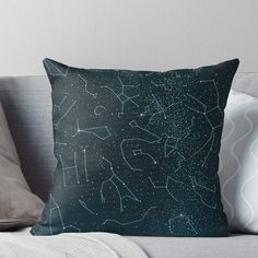 the stars in the night sky are shining brightly on this throw pillow, which is sitting on a couch