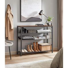 a shelf with shoes and other items on it next to a bed in a room