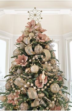 a christmas tree decorated with ornaments and bows