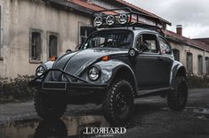 an old style car parked in front of a building